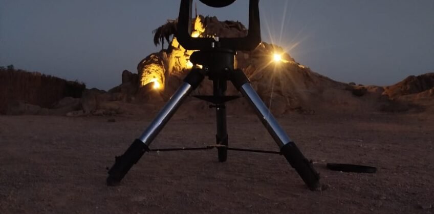 Professional telescope on a tripod set up for stargazing in the Egyptian desert under a moonlit sky, Stargazing Safari tour